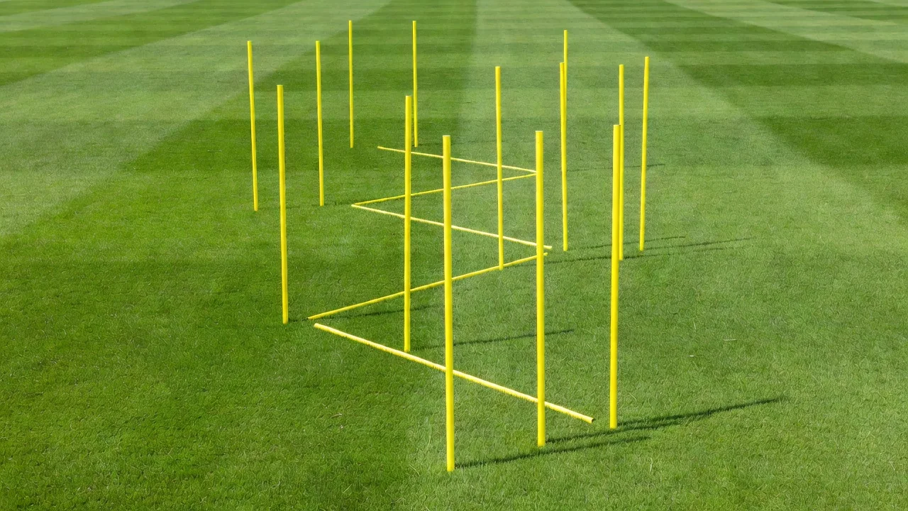Yellow resistance poles in a zigzag sprint pattern on bright grass