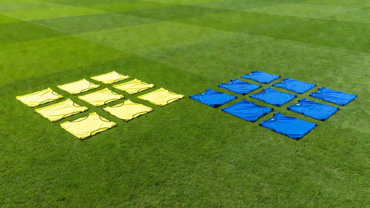 Yellow bibs arranged in a square zone next to blue bibs in a diamond zone on grass